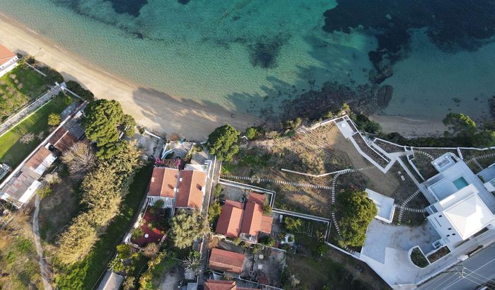 The Achladies Beach Cottages are the pair to the right of centre, Achladies, Skiathos